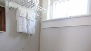 Un bagno piccolo con il water, un lavandino e un portasciugamani.