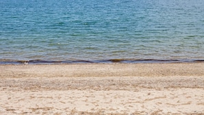 A beach with clear water and a sandy shore. - Tranquil Getaway at the Dolphin Sunday cottage located at the Oceana Cottages (North Truro)