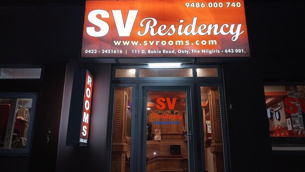 A hotel entrance with a sign reading "SV Residency" and contact information. - SV Residency (Ootacamund)
