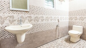 A bathroom with a sink, toilet, and shower. - SV Residency (Ootacamund)