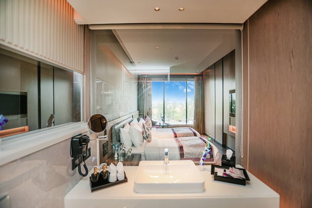 A modern bathroom with a large sink, a mirror, and a telephone.