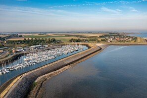 Stunning marina views with boats docked along a serene waterway, surrounded by residential homes and open fields.