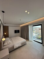 Deluxe Double Room, Balcony | Minibar, in-room safe, individually furnished, desk