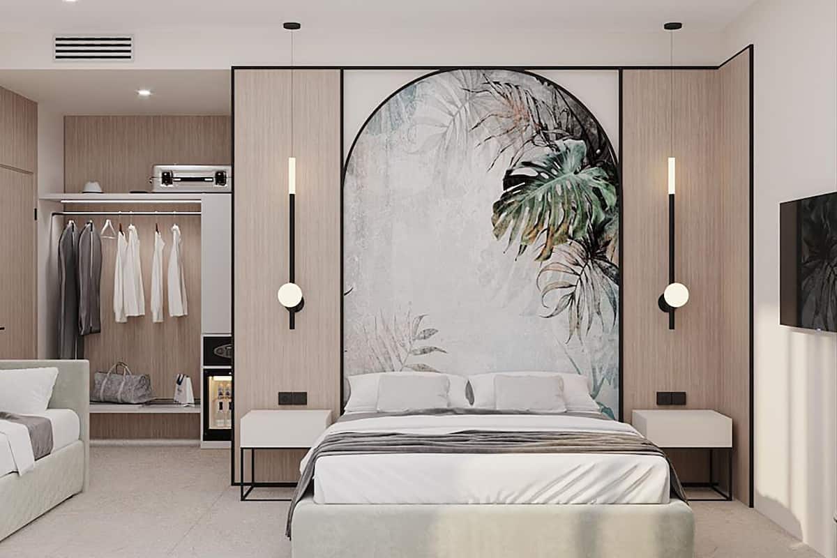 A modern bedroom with a large bed, a wardrobe, a bedside table, and a wall-mounted artwork.