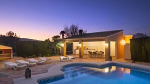 A swimming pool with lounge chairs, a covered patio, and a kitchen area. - Villa Armonia by Interhome (Jávea)