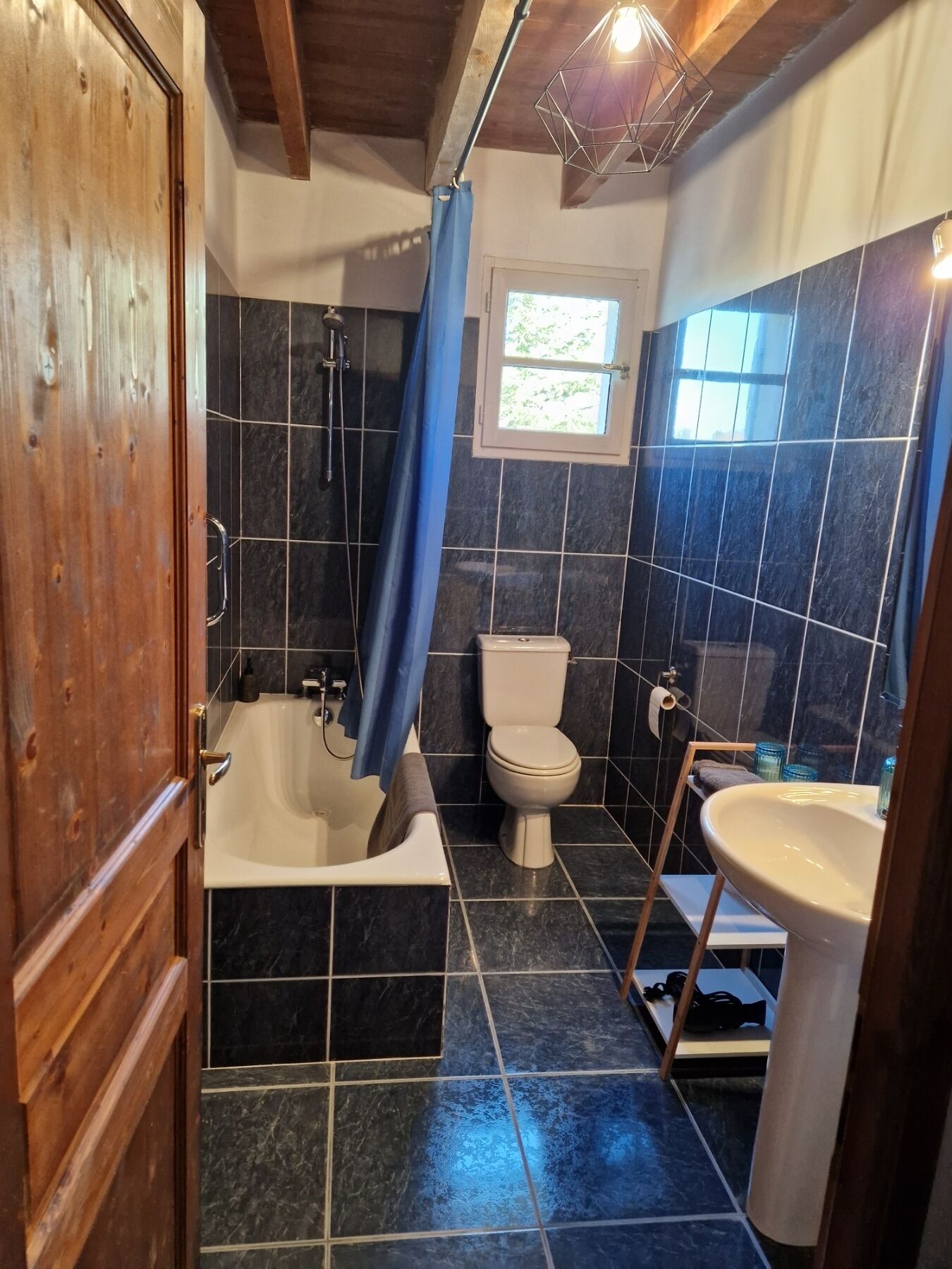 Un bagno con vasca, servizi igienici e lavandino.