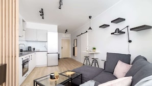 A modern apartment with a kitchen, dining area, and living room.