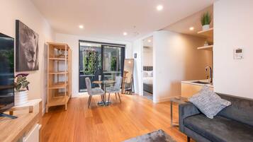 Basic Apartment, 1 Queen Bed | Living area | TV