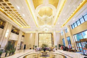 A spacious lobby with a grand chandelier, large windows, and a central seating area. - Jasmine International Hotel (Renshou)