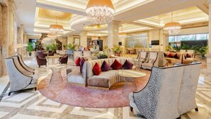 A spacious lobby with multiple seating areas, large chandeliers, and a central coffee table. - Jasmine International Hotel (Renshou)