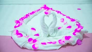 A white swan-shaped decoration with pink petals.