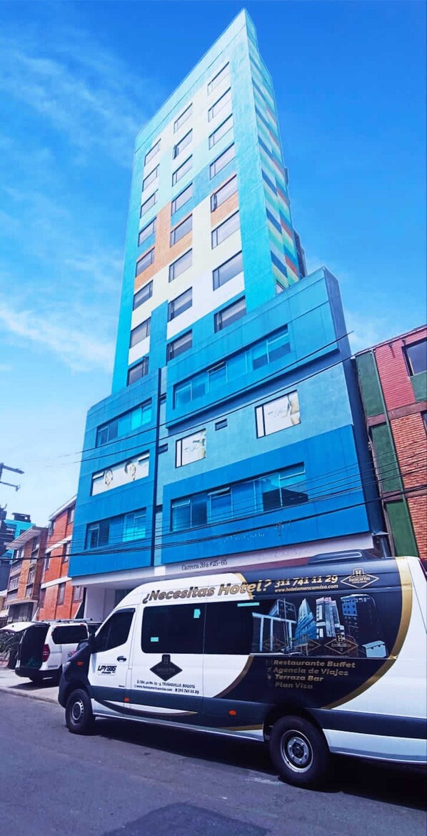A modern hotel building with multiple floors and a prominent blue facade.