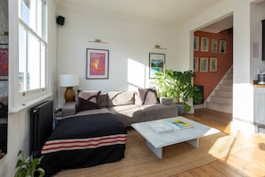 Departamento básico, 1 cama matrimonial | Área de sala de estar | Televisión