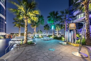 Stroll along the walkway, surrounded by palm trees and take in the city view from the comfort of a bench.