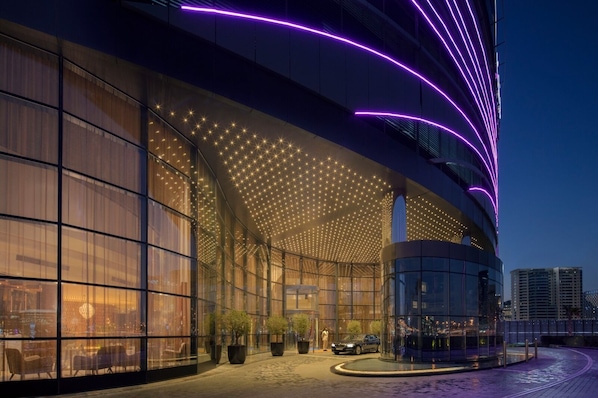 Experience the unique architectural design of this hotel, featuring a curved facade with expansive glass windows and a starry ceiling.