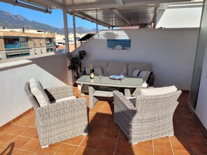 Enjoy al fresco dining and social gatherings on this patio with a round table and comfortable seating for four.