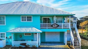 A two-story house with a blue exterior, a covered porch, a balcony, and a staircase leading to the garage. - Ocean & Sound Views, Game Room, Steps to Beach! (Surf City)