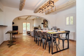 A spacious dining area with a long table set for multiple people, surrounded by chairs. - Lou Lume - Four Bedroom Villa, Sleeps 8 (Peymeinade)