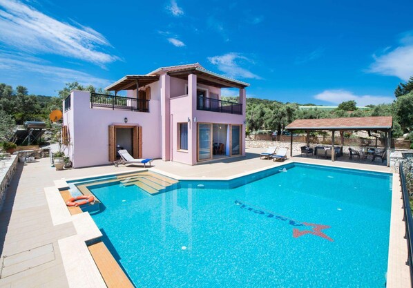 A two-story building with a swimming pool.