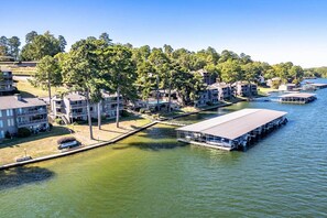 A lakeside property with multiple buildings, docks, and a covered boat launch area. - Hot Springs Vacation Rental w/ Game Room! (Hot Springs)
