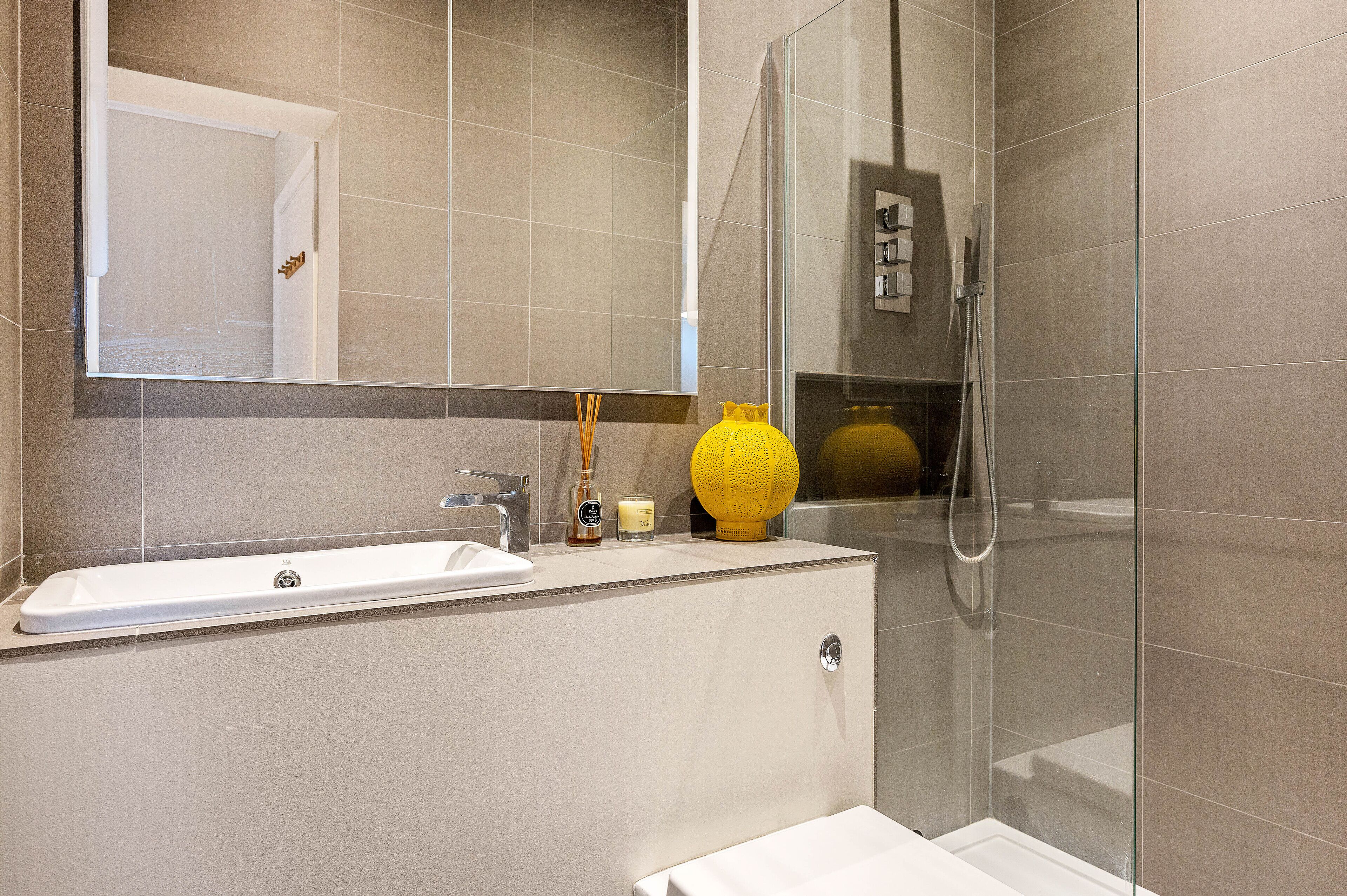 A modern bathroom with a bathtub, a sink, and a shower.