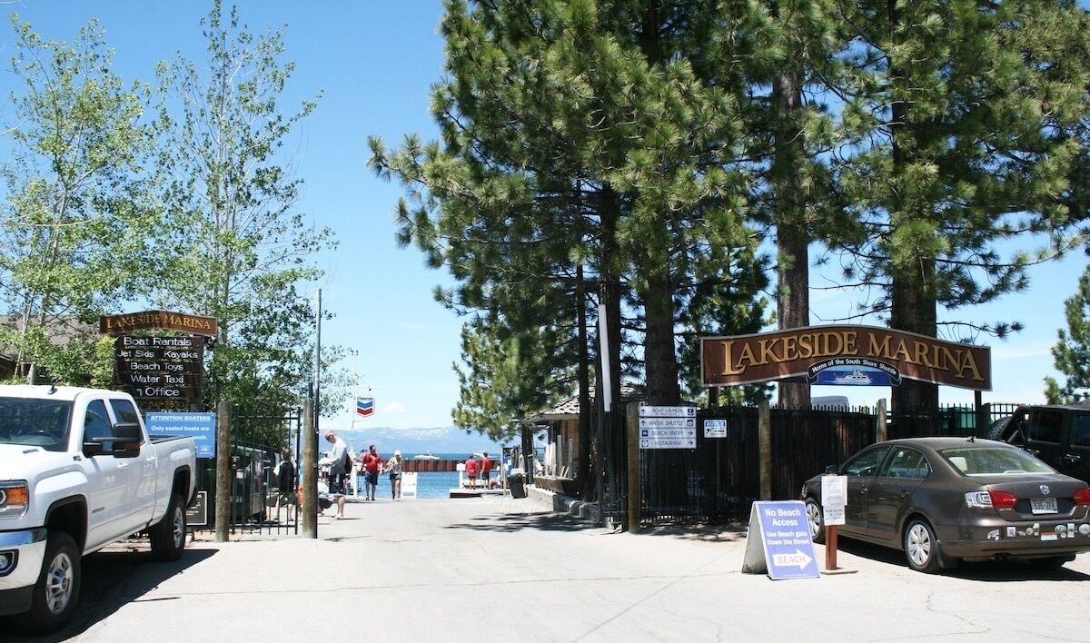 A marina entrance with a sign for Lakeside Marina, listing amenities like boat rentals, jet skis, and water taxis.