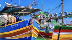 A harbor with several colorful boats docked, including one named 'KRISTURE 1 VALLETTA'. - Ewa Apt - 3-bed Near Sliema - St Julians Seafront (Gzira)