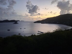 A coastal view with boats, a pier, and distant landforms. - Stunning 3 Bed Villa Overlooking Friendship Bay (Bequia Island)