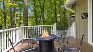 A deck with a fire pit, outdoor furniture, and a white railing. - Spring Creek Cottage 1 Bedroom Chalet by RedAwning (Sevierville)