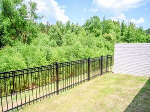 Surrounded by lush greenery, this outdoor space offers a serene escape.