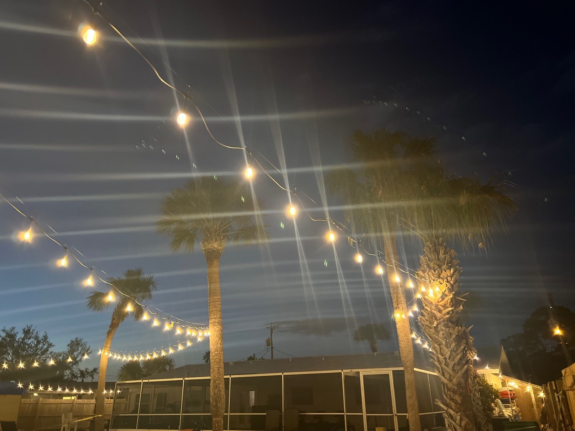 A building with a glass facade and a string of lights above.
