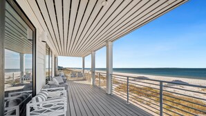 A wooden deck with white railings overlooking a beach. - Ginger Snap: 5 BR Beachfront Home- Elevated Pool, Pet Friendly, Sleeps 20! (St. Joe Beach)