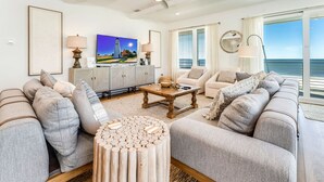 A living room with a sofa set, a coffee table, and a TV.