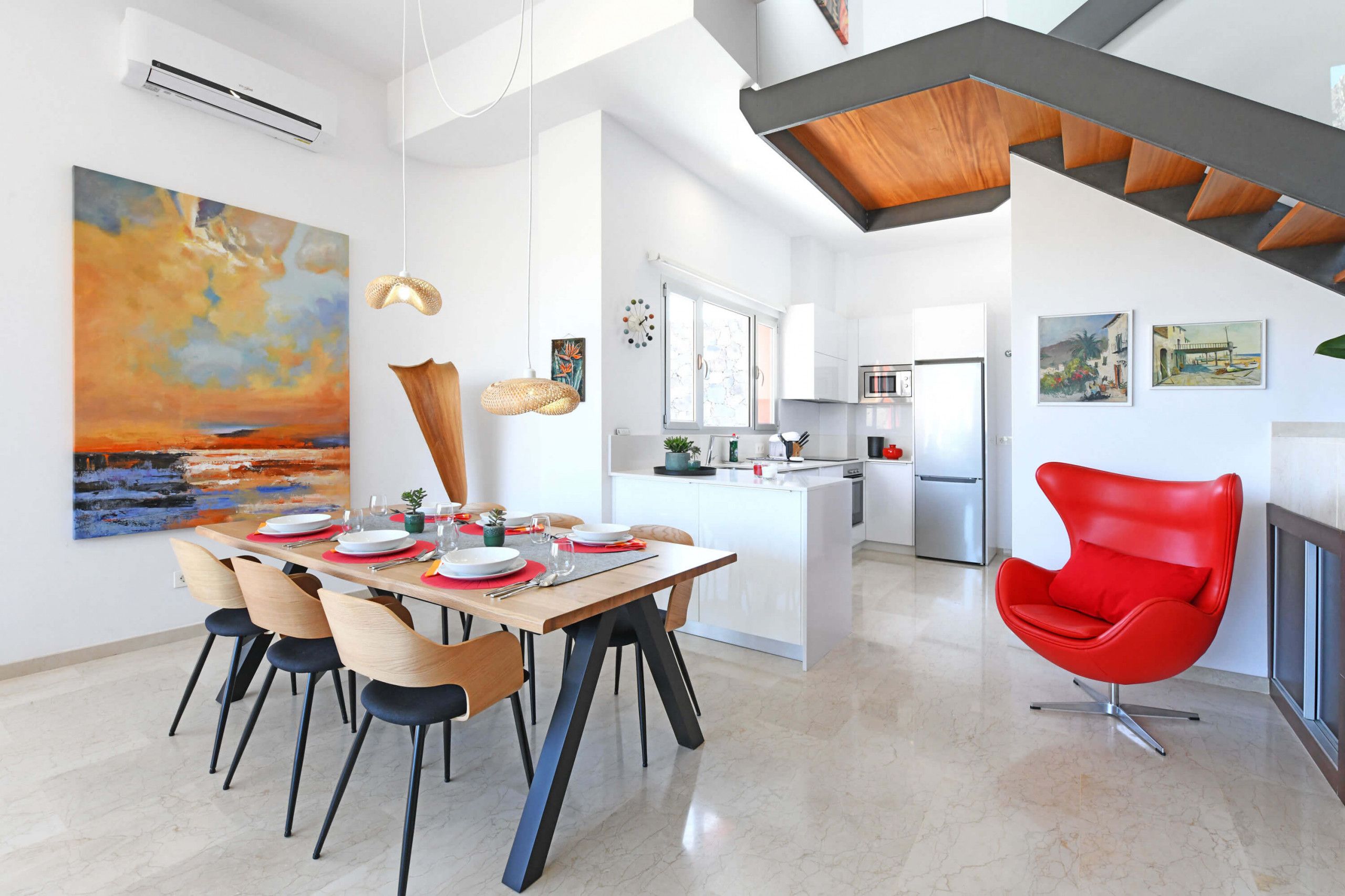 A modern kitchen with white cabinets, a central island, and stainless steel appliances.