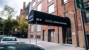 A building with a sign for KAMA Central Park Hostel at 36 W. - Kama Central Park Hostel (New York)