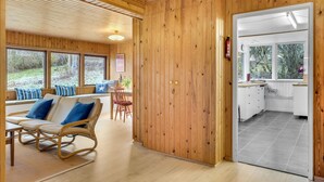 A wooden interior with a dining area, a kitchen, and a view of the outdoors. - 2 bedroom amazing home in Jægerspris (Jægerspris)