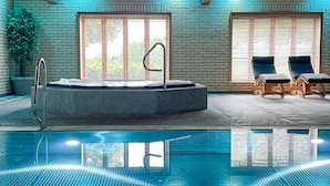A swimming pool with a hot tub, two lounge chairs, and a potted plant. - Pine Boutique Lodge With hot tub for Couples & dog (York)