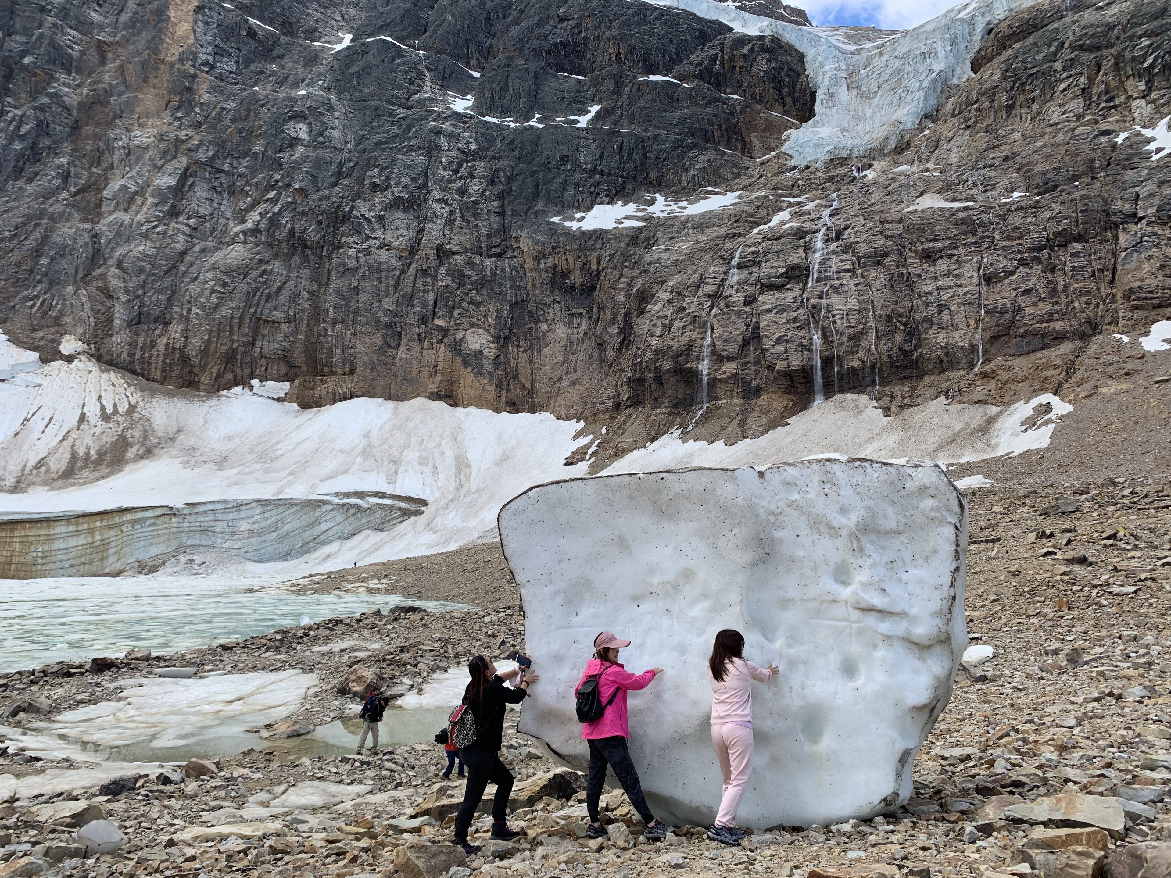 A large ice formation with people examining it.