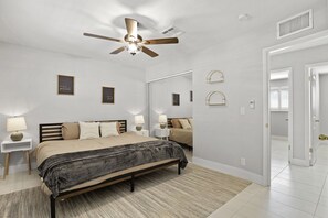 Cozy retreat with a bed, bedside tables, and a large mirror.