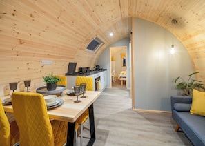 Un interior acogedor de madera con comedor, cocina y zona de estar.