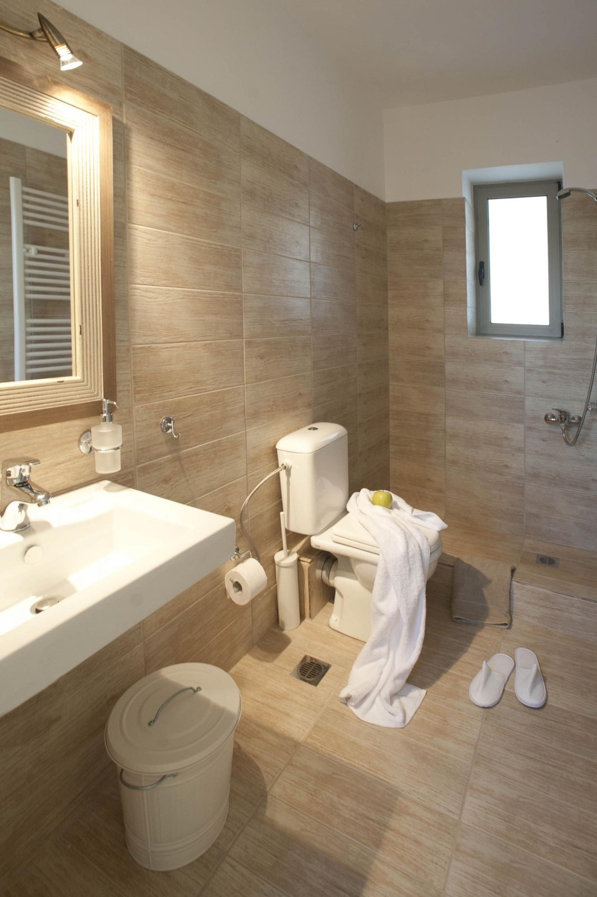 A modern bathroom with a sink, toilet, and shower.
