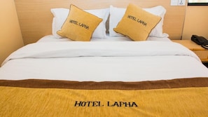 A hotel bed with two pillows labeled "HOTEL LAPHA" and a bedspread with the same text. - Hotel Lapha (Kathmandu)