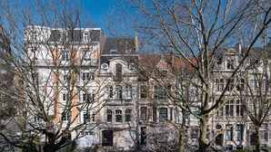A historic building with multiple stories, large windows, and a prominent entrance. - Molière Design residence  (Brussels)