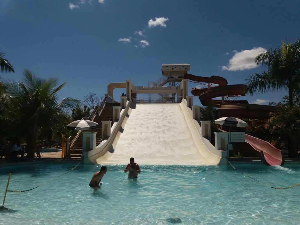 A water park with a large water slide and a pool area.