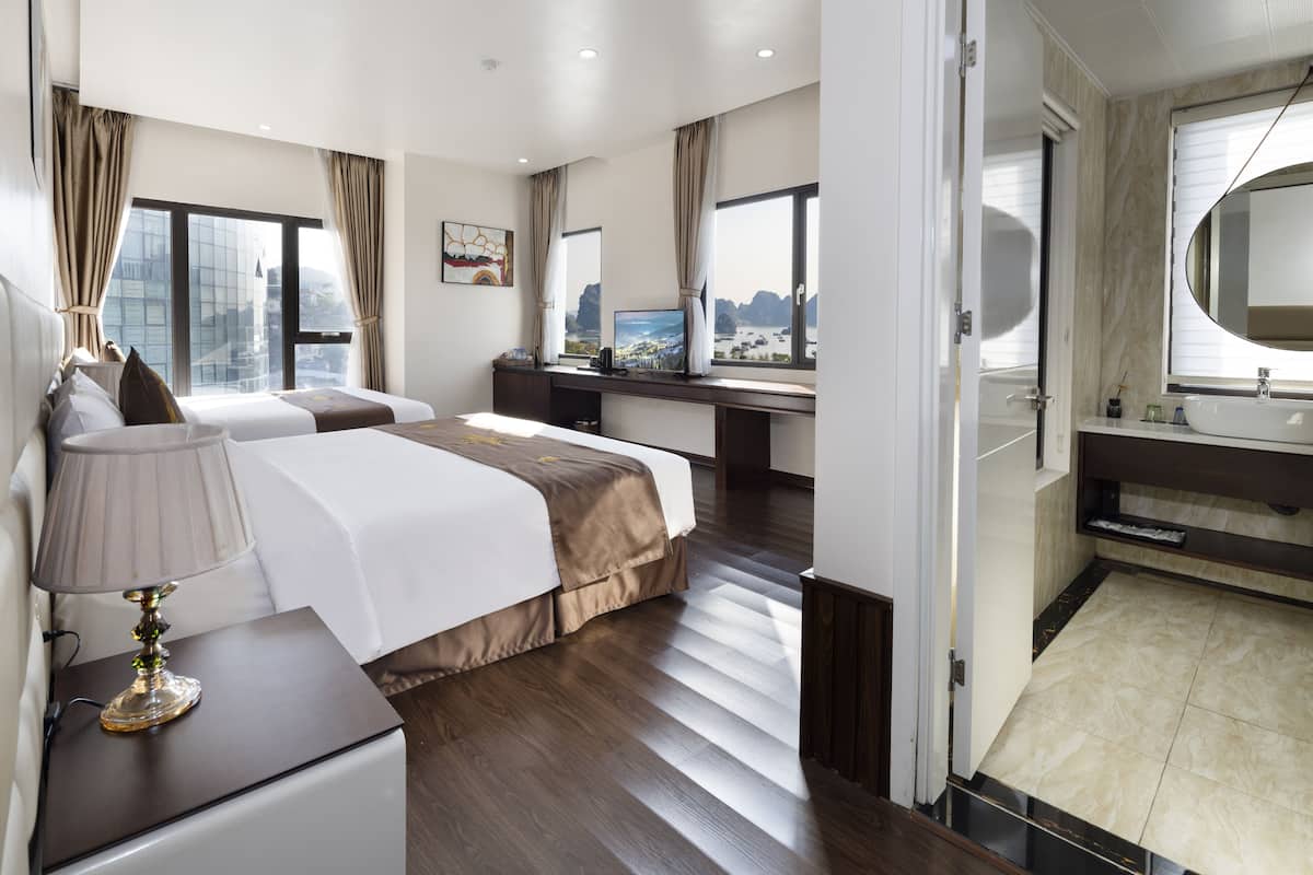 Una habitación de hotel con cama, escritorio y baño.