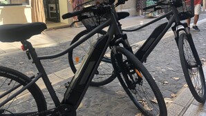 A bicycle parked on a cobblestone street.