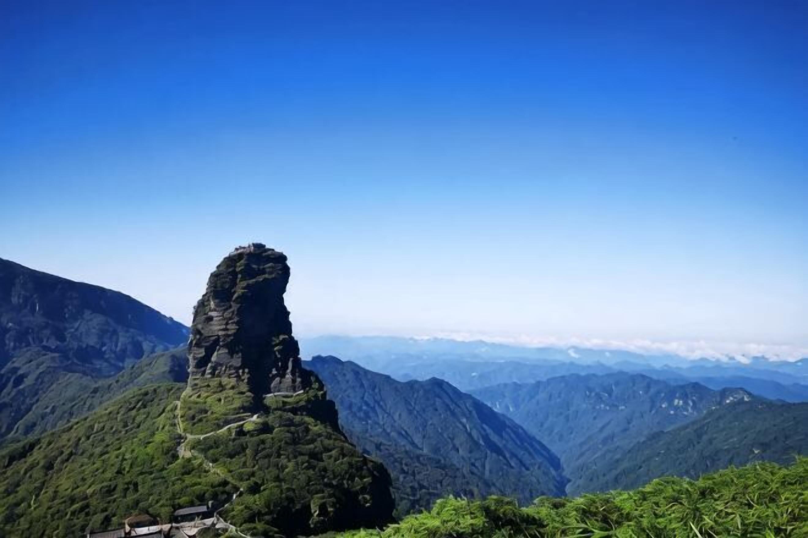 A mountainous landscape with a prominent rock formation.