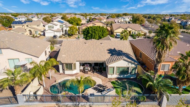 A residential area with houses, a swimming pool, and a tennis court. - Hole in One with pool and putting green! (Goodyear)