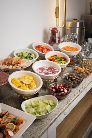 A buffet table with various food items and a coffee machine. - Bratus Hotel Aqaba (Aqaba)