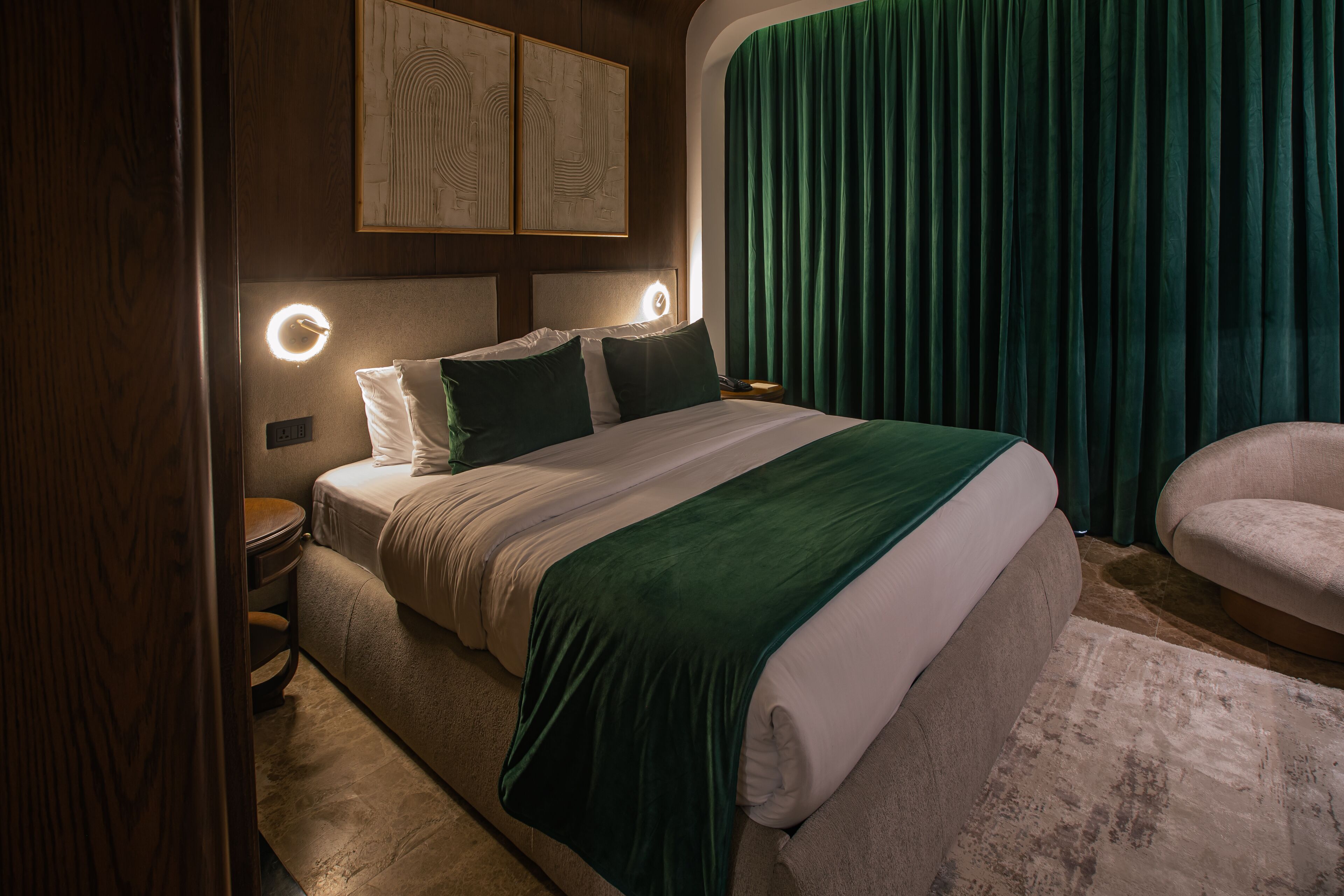 A neatly arranged bedroom with a bed, bedside tables, and a chair.